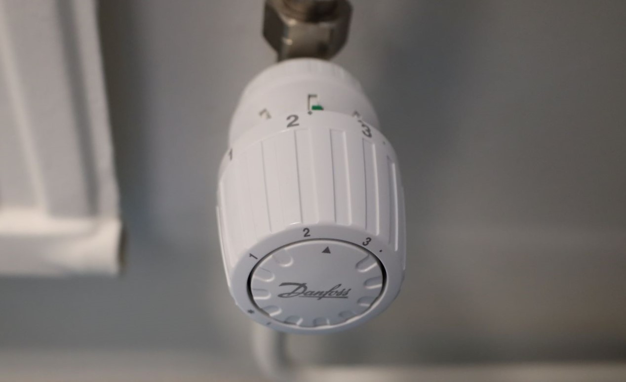 White radiator thermostat on a wall.